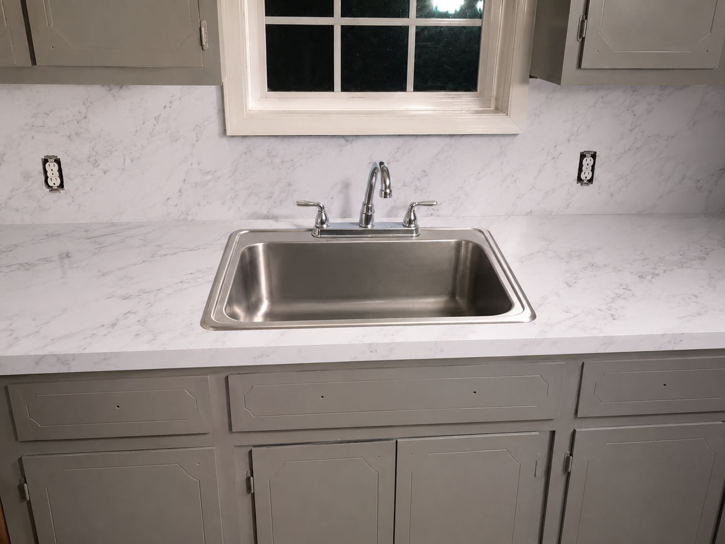 Same kitchen countertop and backsplash resurfaced in a bright white marble-look finish